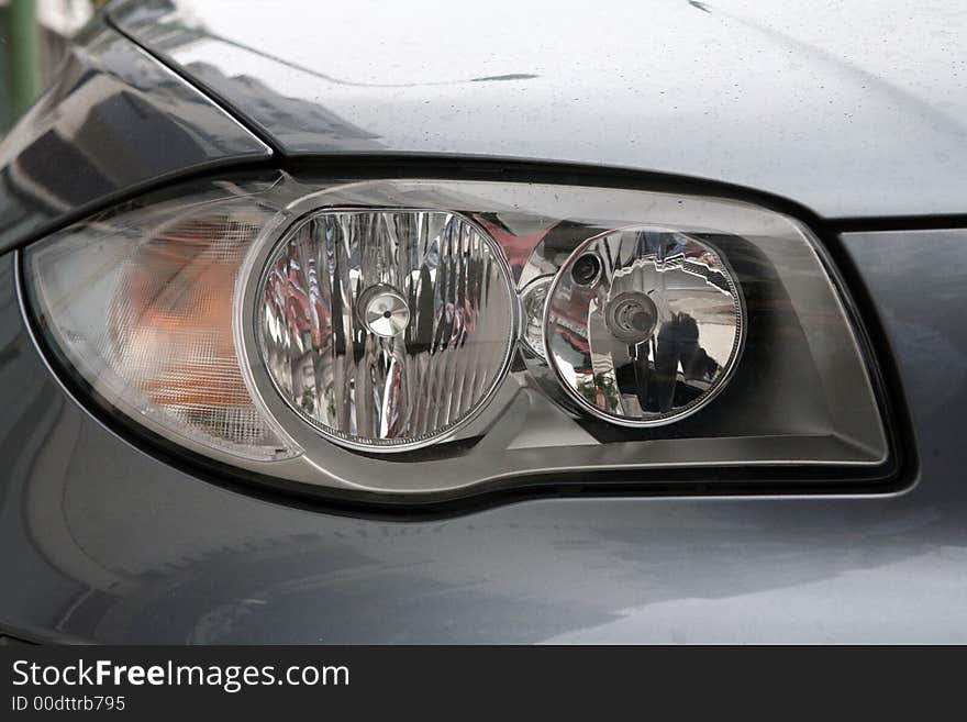 Head lights of a sport grey car