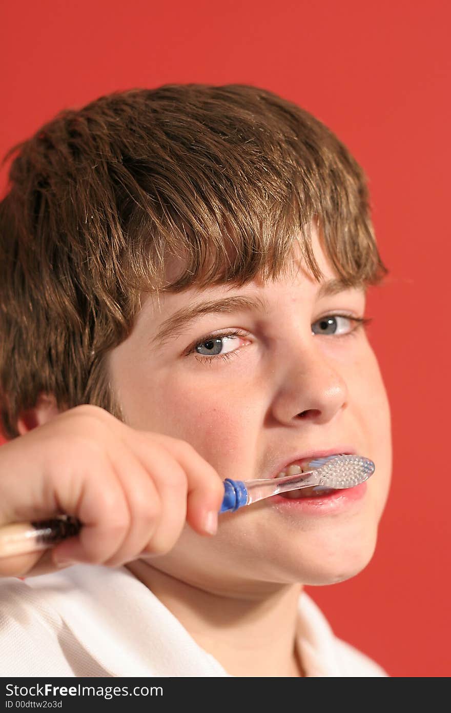 Boy brushing teeth vertical up