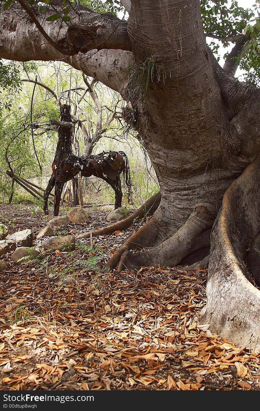 Detail view of an original oxidize sculpture of a centaur in front of a tree in Alamos, Sonora, Mexico, Latin America. Detail view of an original oxidize sculpture of a centaur in front of a tree in Alamos, Sonora, Mexico, Latin America