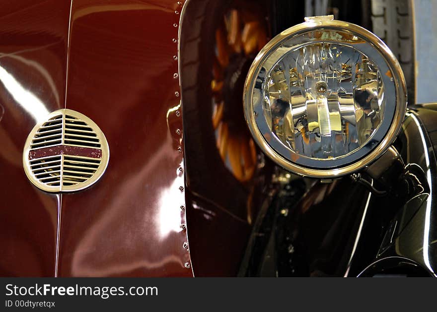 Headlight and front grill and vintage red car