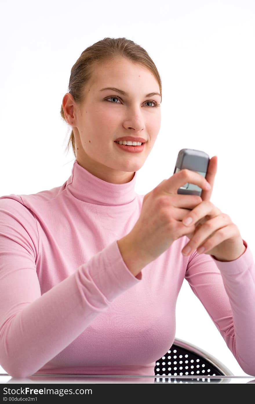 Young woman is looking straight forward while holding her cell phone. Young woman is looking straight forward while holding her cell phone