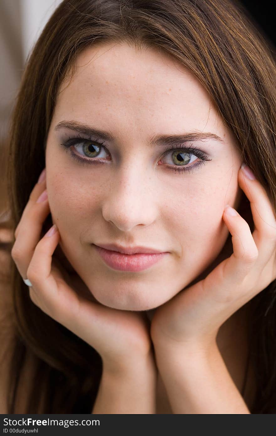 Relaxed young woman is looking into the camera. Relaxed young woman is looking into the camera