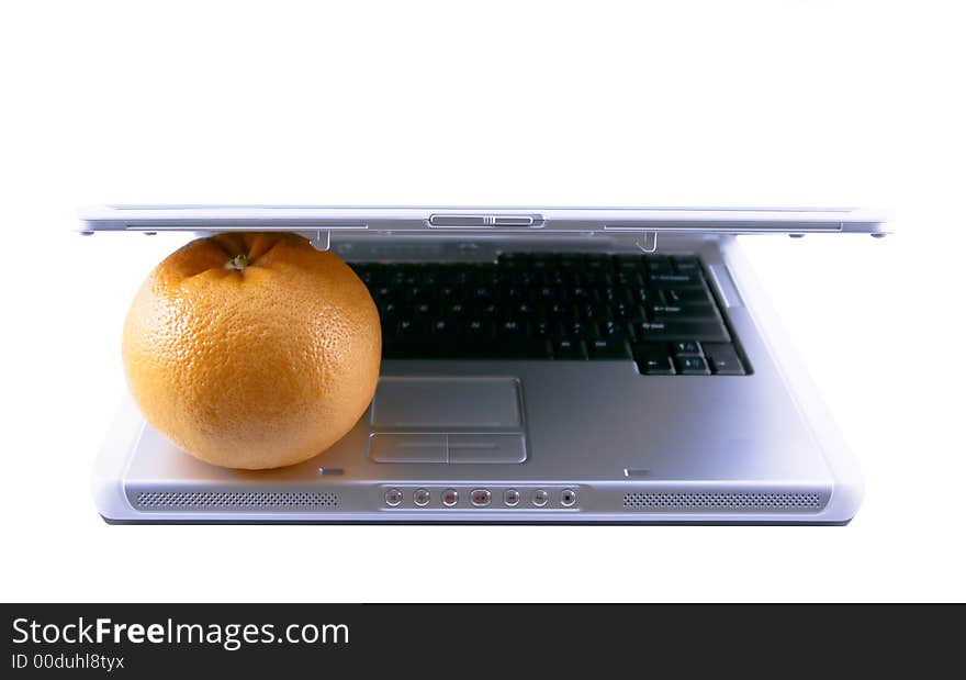 Laptop and grapefruit selected on a white background