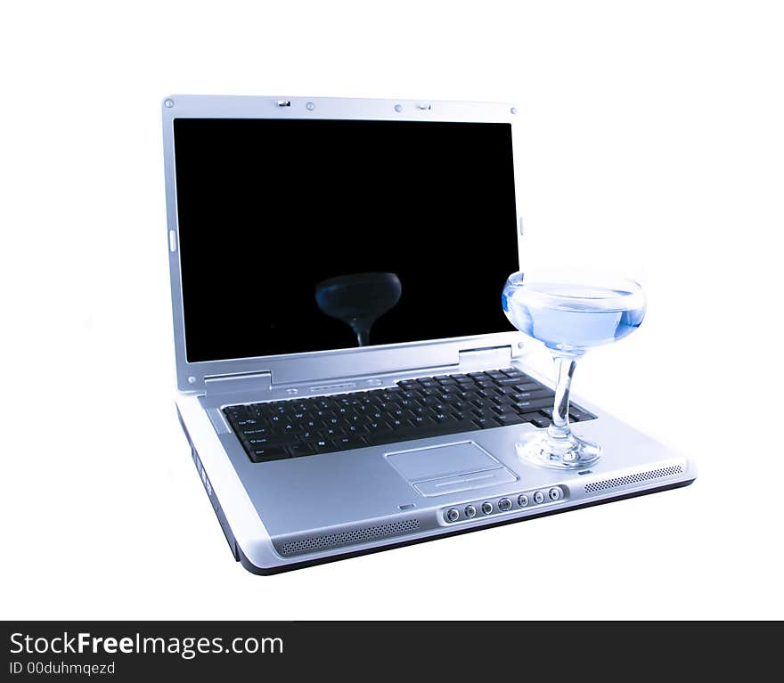 Laptop and a glass with a blue cocktail selected on a white background