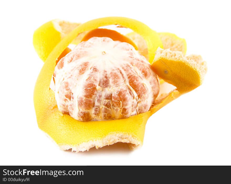 Peeled grapefruit next to its