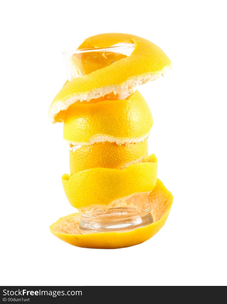 Empty glass with a grapefruit peel selected on a white background