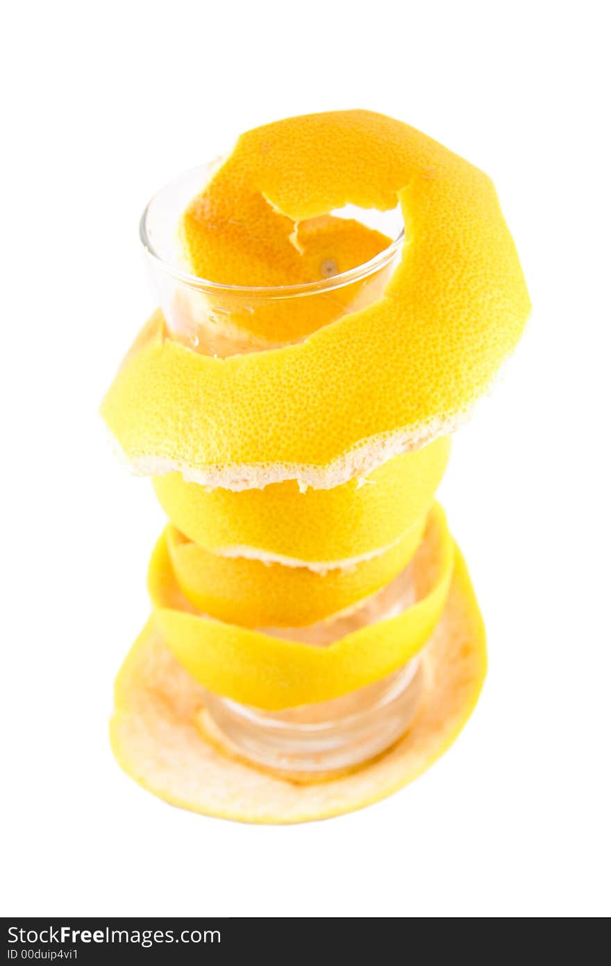 Empty glass with a grapefruit peel selected on a white background