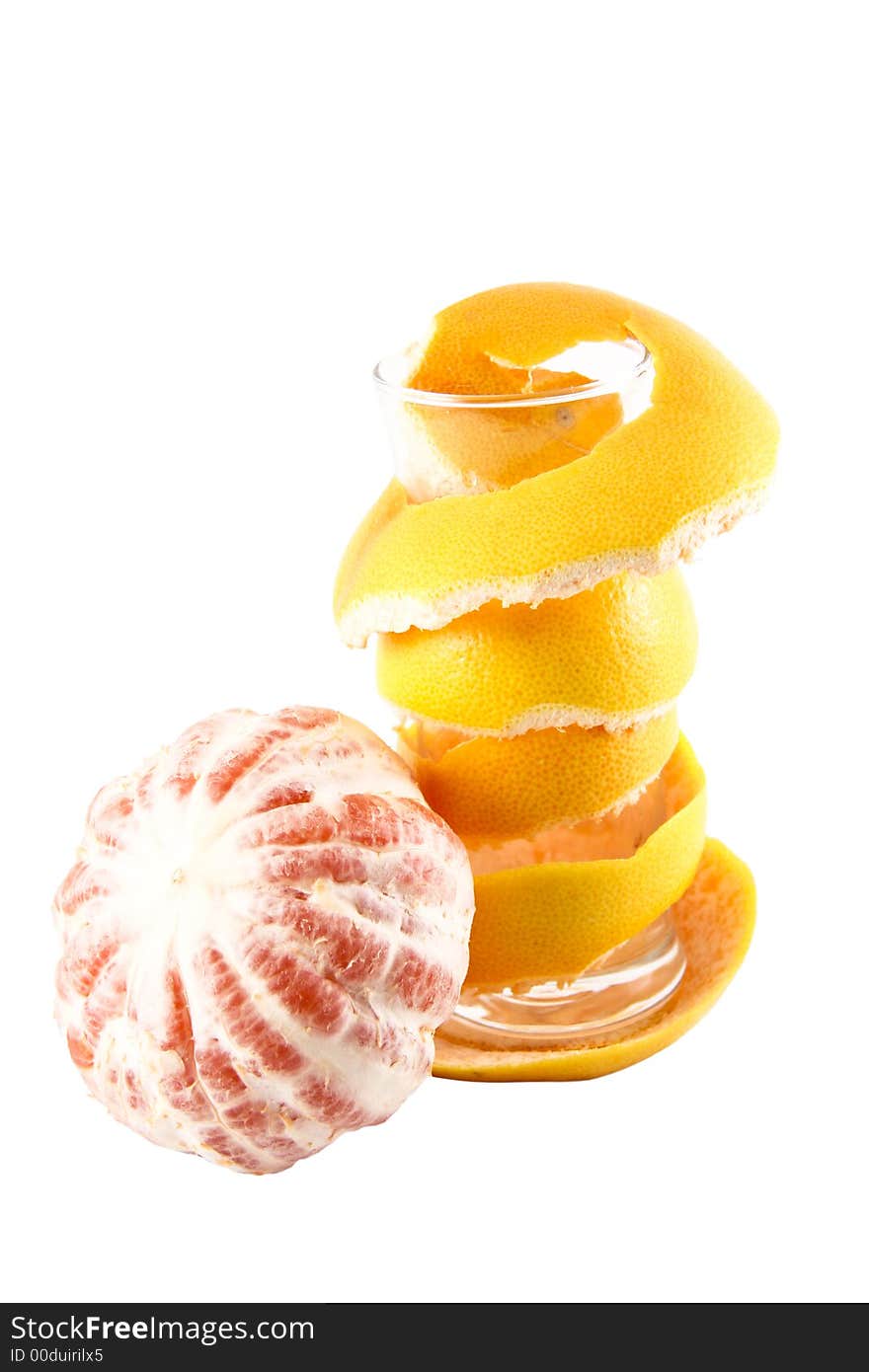 Empty glass with a grapefruit peel selected on a white background