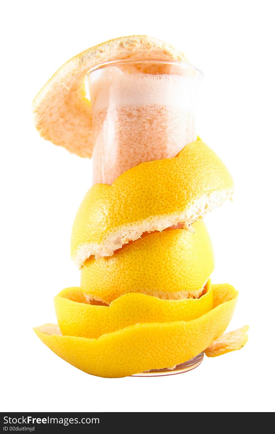 Glass with juice and a grapefruit peel selected on a white background