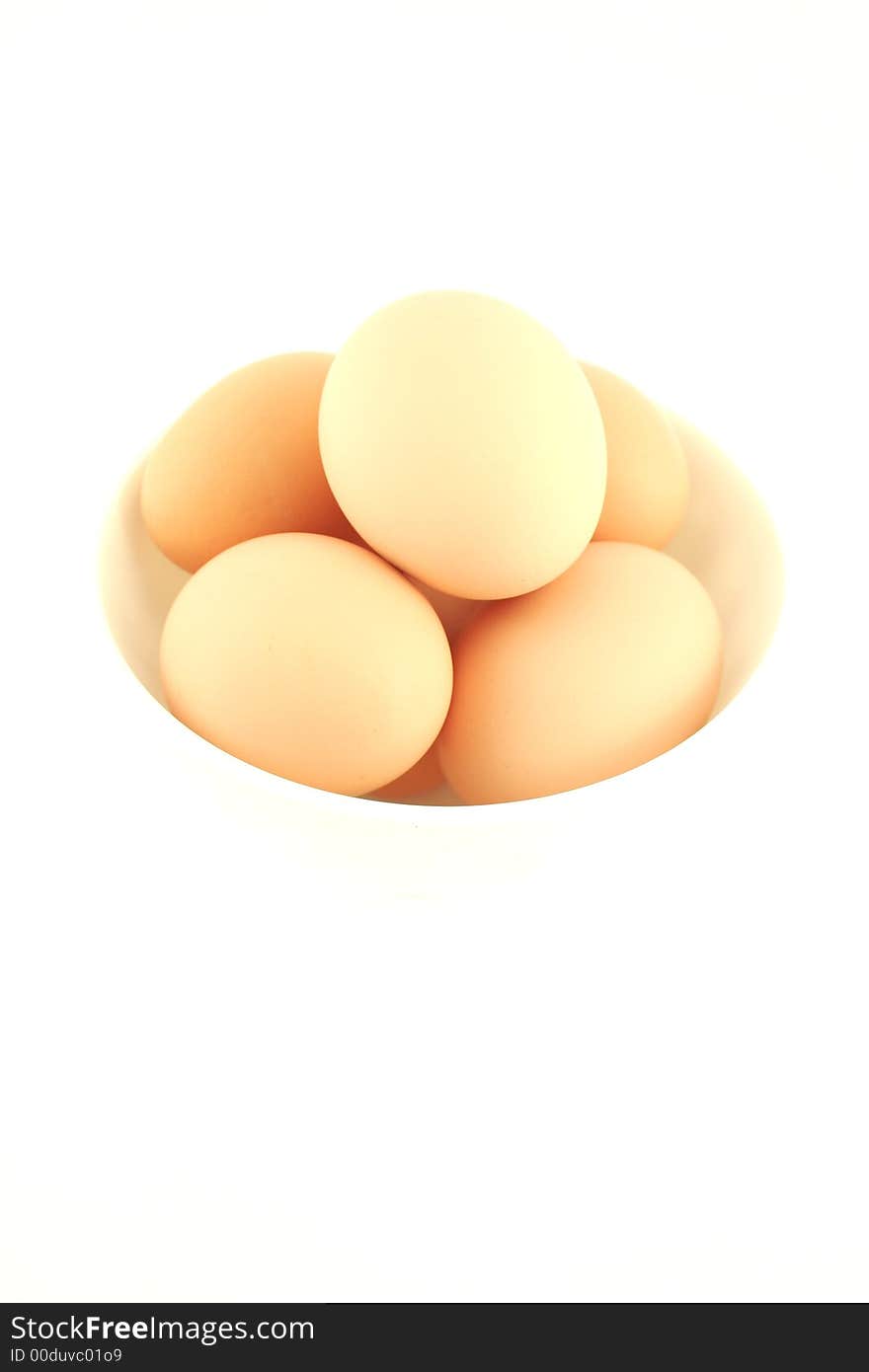 Fresh eggs in  white bowl isolated