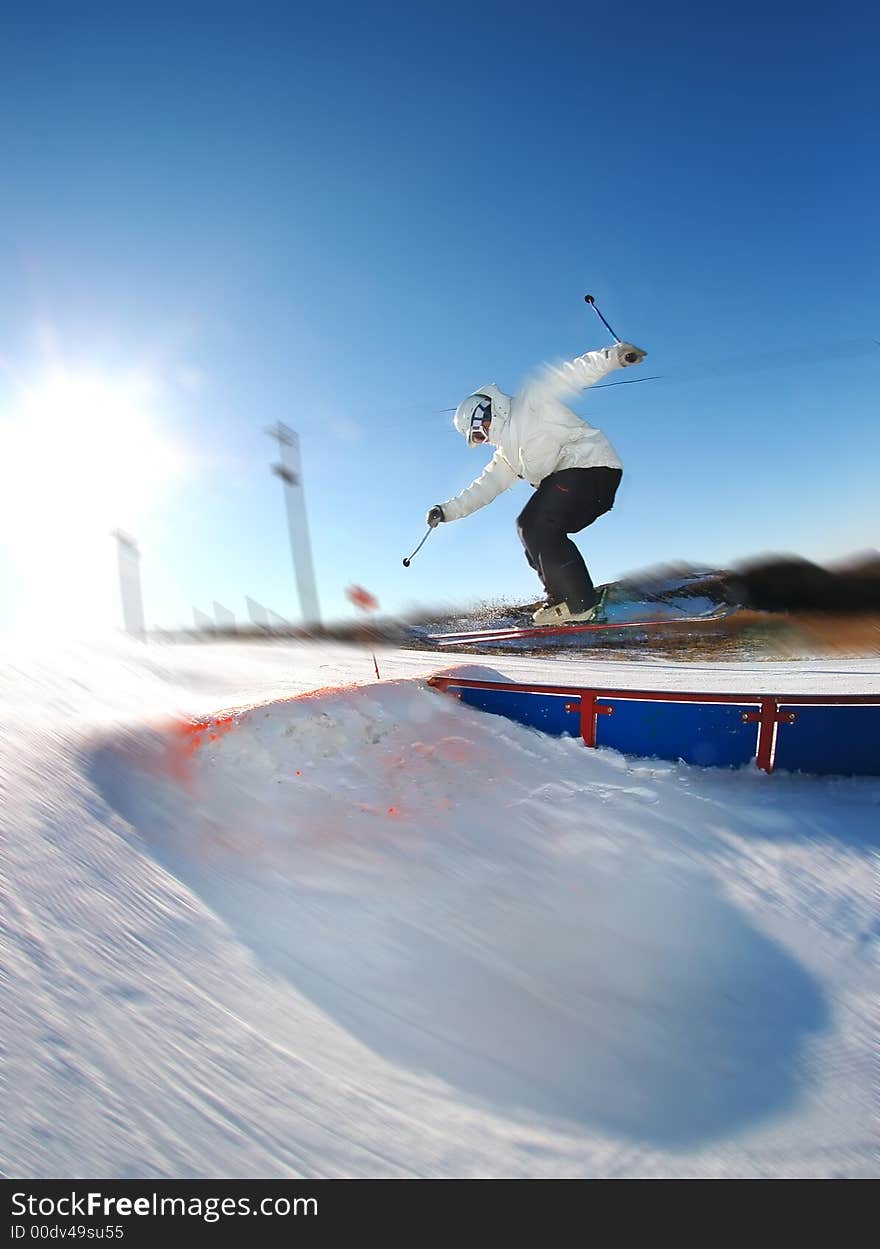 Free skiier on a rail spinning. Free skiier on a rail spinning