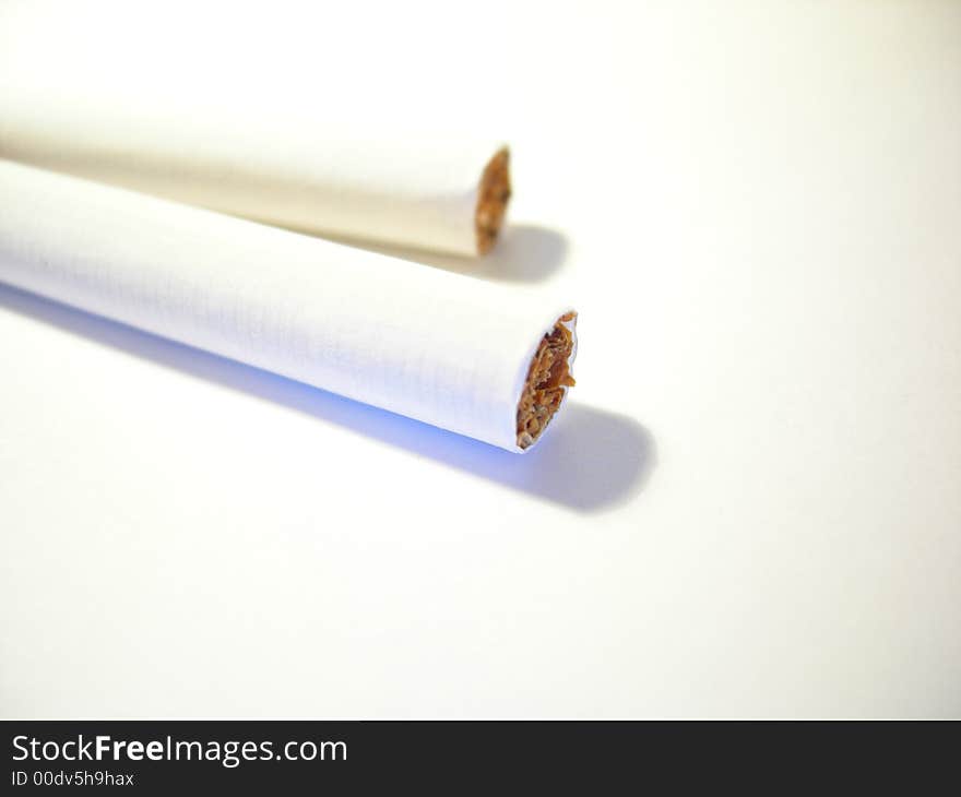 Two cigarettes on a white background. Two cigarettes on a white background