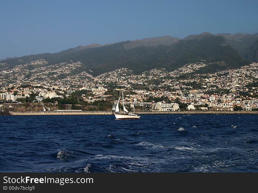 Yacht and Funchal as background, Madeira, Portugal