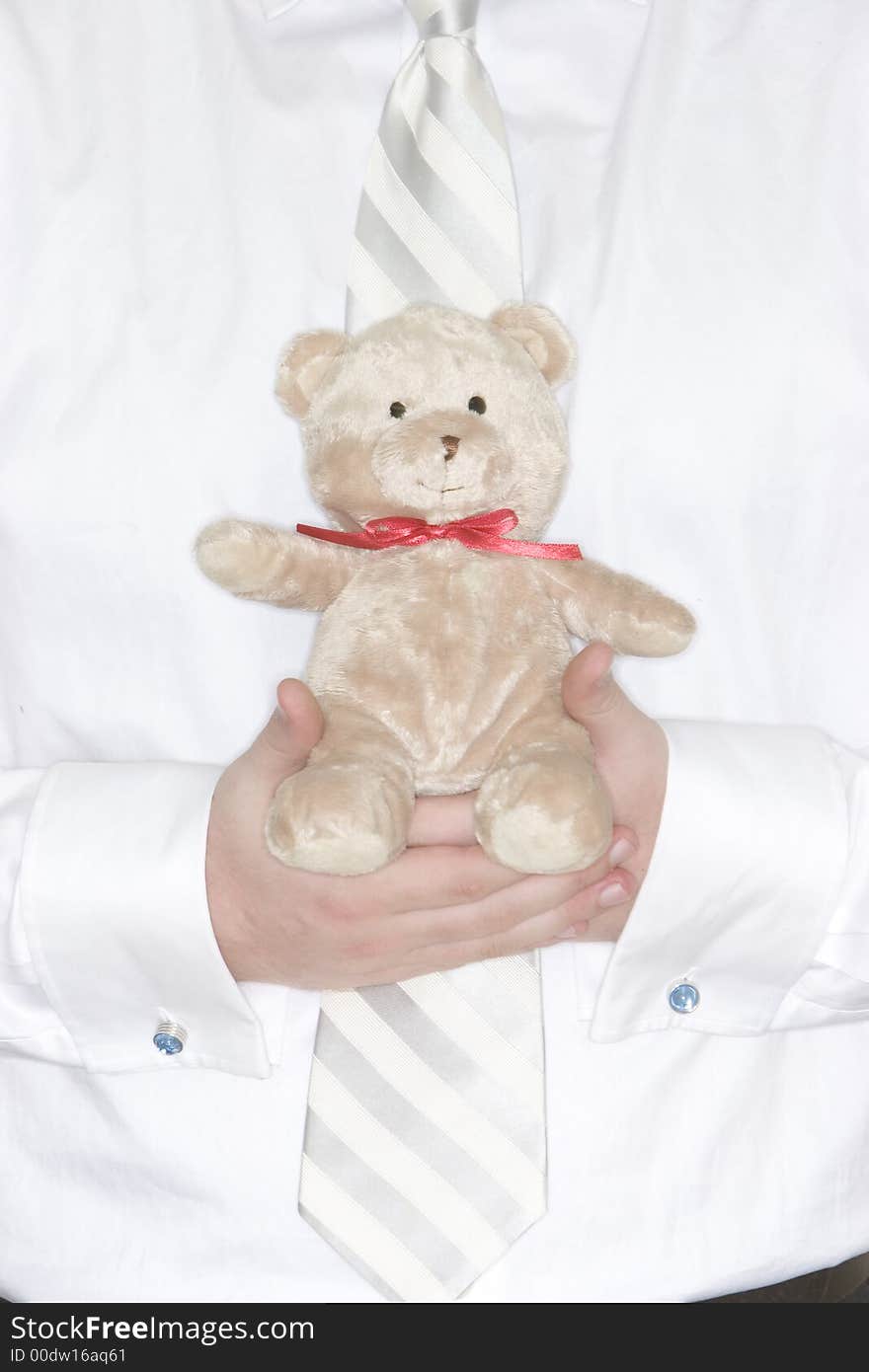 Businessman holds in his hands a cute teddy bear for comfort. Businessman holds in his hands a cute teddy bear for comfort