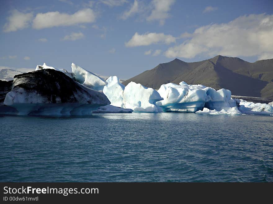 Icebergs on Jokulsarlon lagoon lit by the sun in Iceland. Icebergs on Jokulsarlon lagoon lit by the sun in Iceland