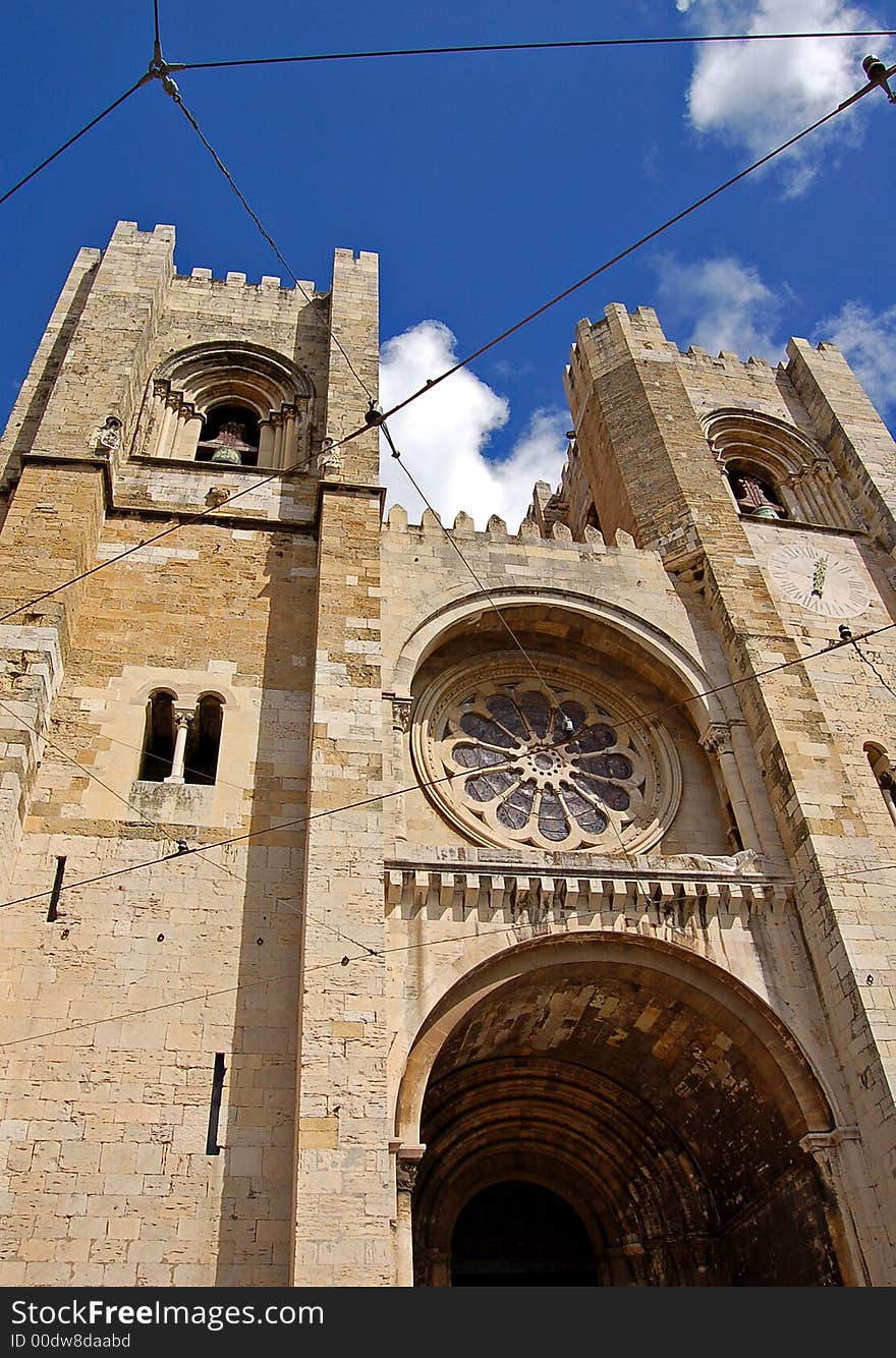 An old church in the middle of the old town of Lisbon. You can see clearly the electric wires of the trams. An old church in the middle of the old town of Lisbon. You can see clearly the electric wires of the trams