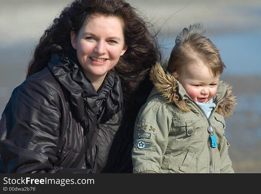 Mother and cute boy on the bea