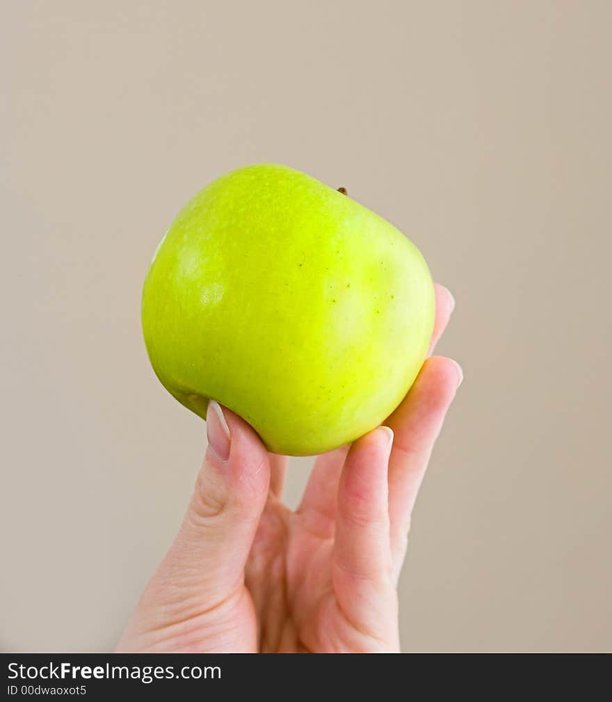 Young hand holding a green apple. Young hand holding a green apple