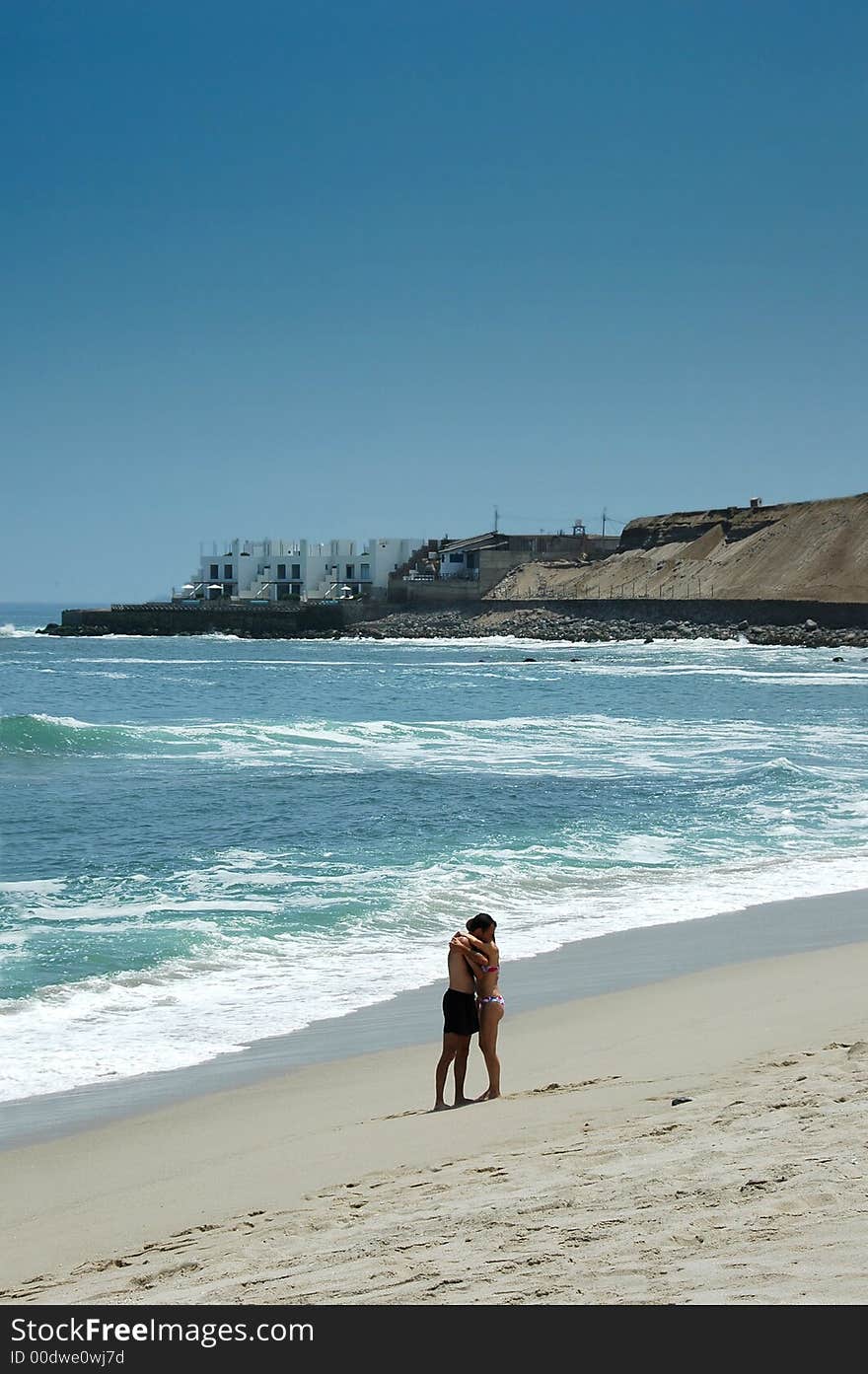 Couple huging at the beach on a sunny day