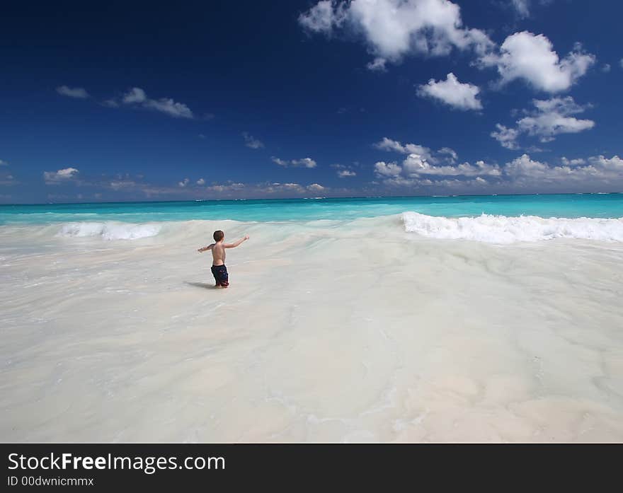 Child explores the ocean waves. Child explores the ocean waves