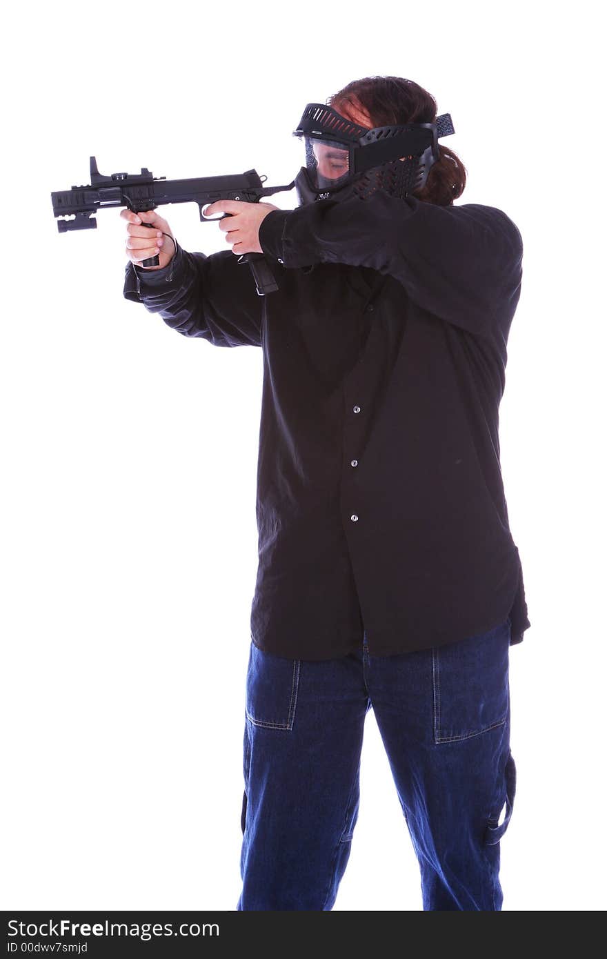 Isolated man in mask and holding gun and getting ready to shoot. Isolated man in mask and holding gun and getting ready to shoot.