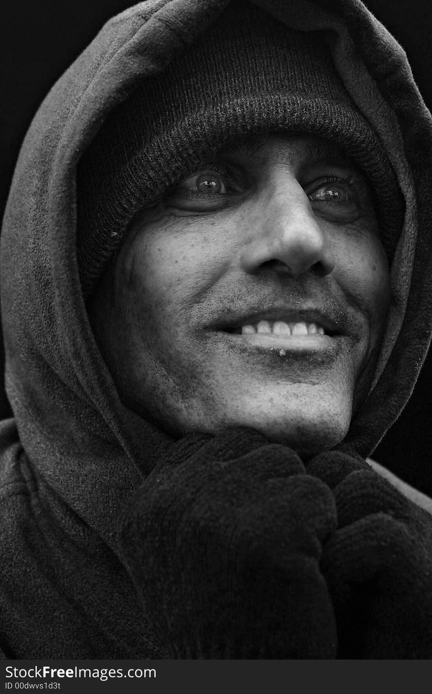 Close up black and white portrait of urban man looking to the side with big smile. Close up black and white portrait of urban man looking to the side with big smile