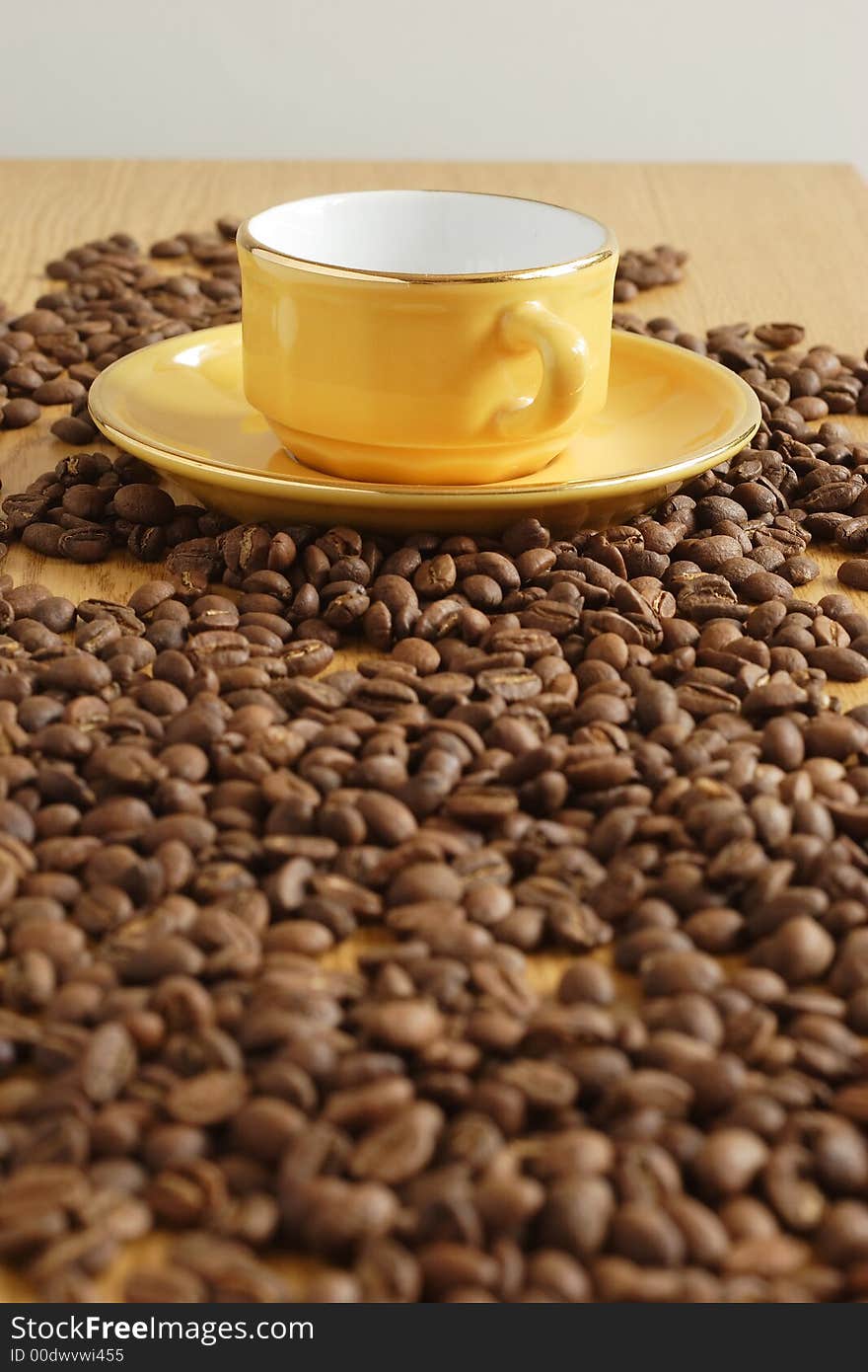 Yellow cup and grains of coffee. Yellow cup and grains of coffee