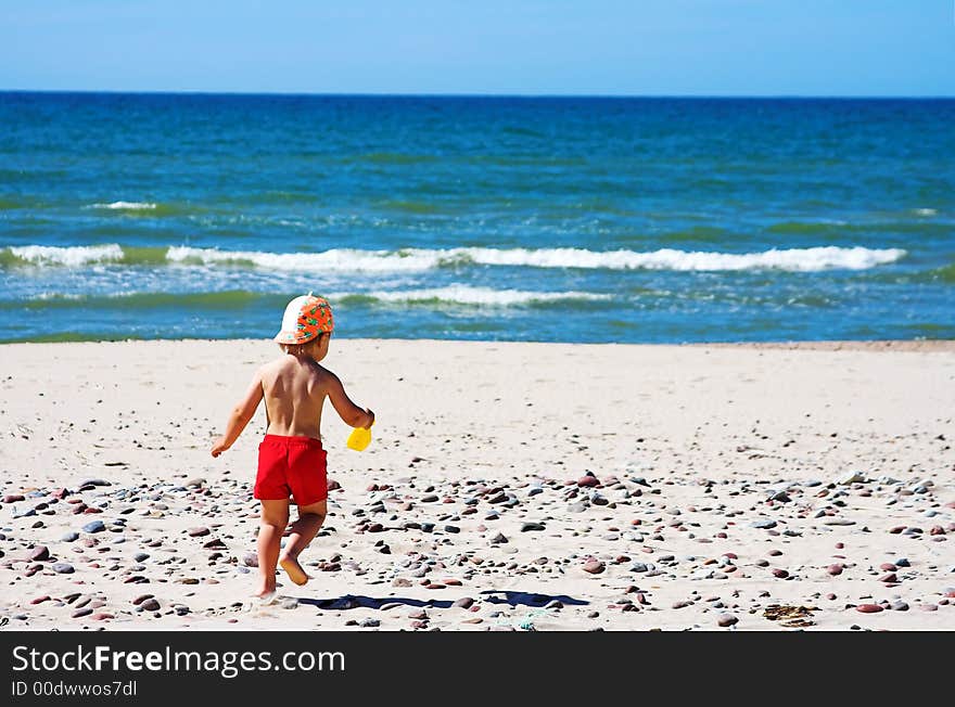 Young boy playing at the beach. Young boy playing at the beach.