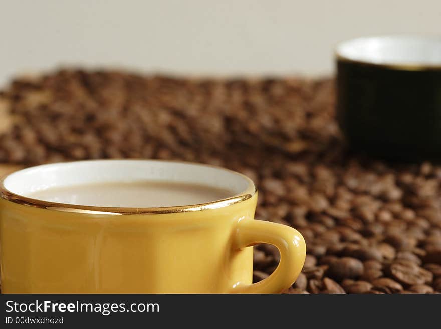 Yellow cup and grains of coffee. Yellow cup and grains of coffee