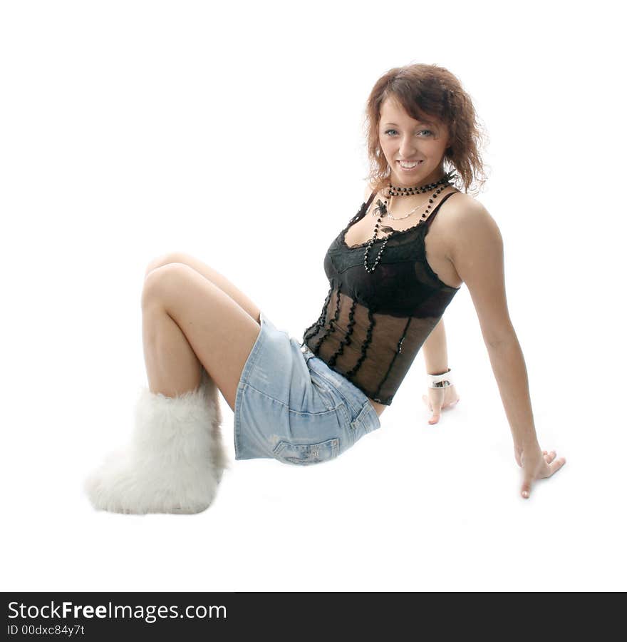 The girl lays on a floor on a white background. The girl lays on a floor on a white background