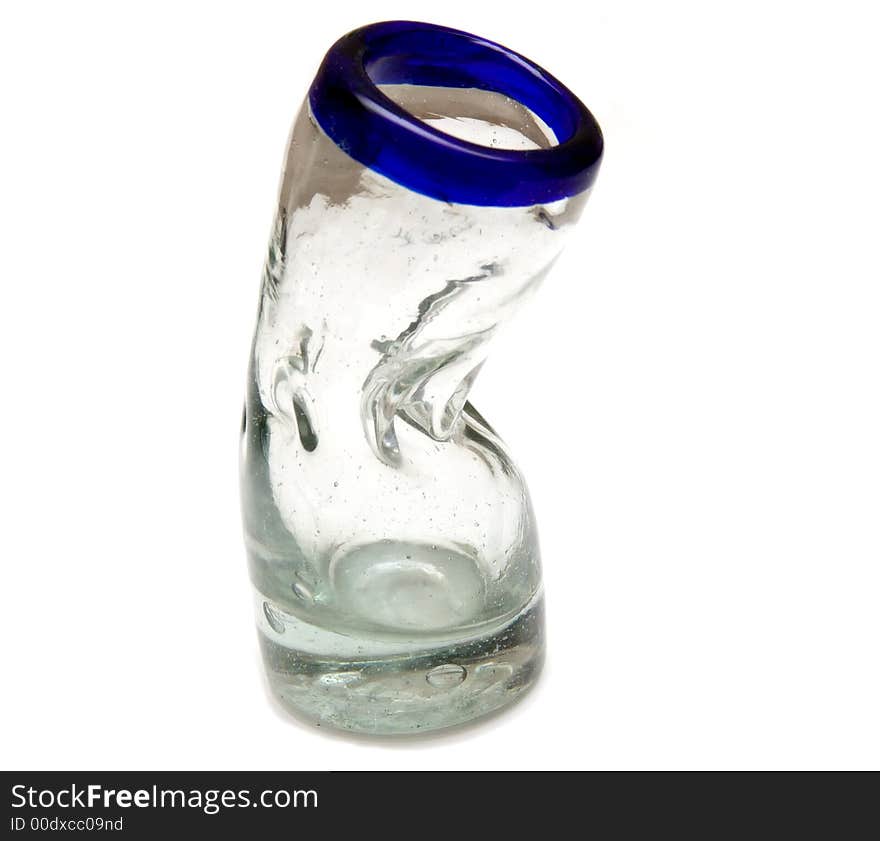 A hand made bent shot glass over white.