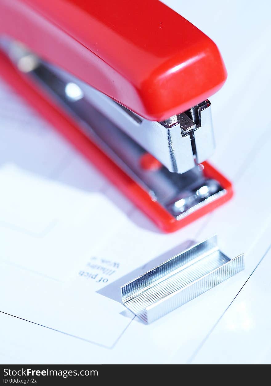 Red stapler with a bunch of staples. Red stapler with a bunch of staples