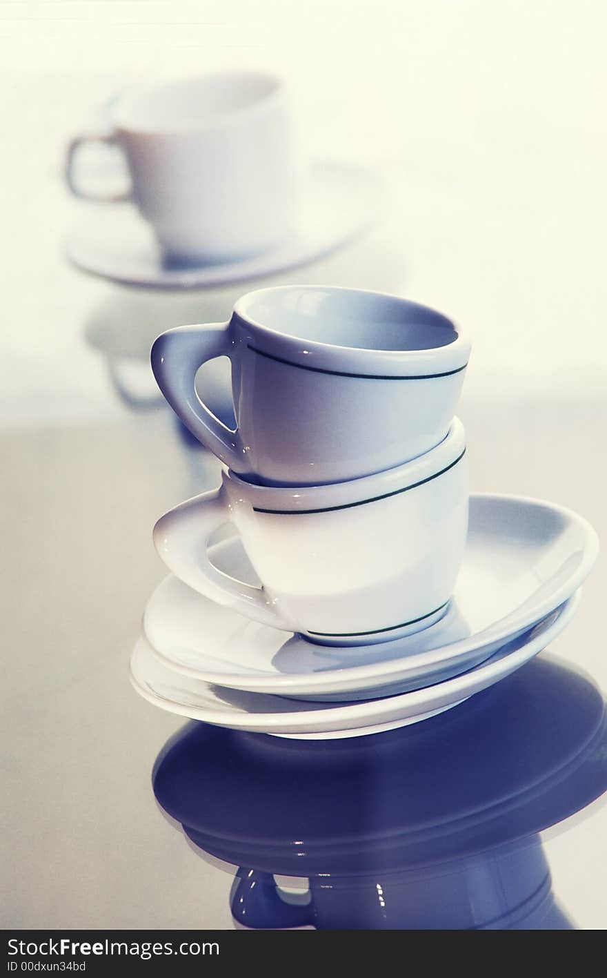 Washed pure utensils, coffee cups and plates on light background