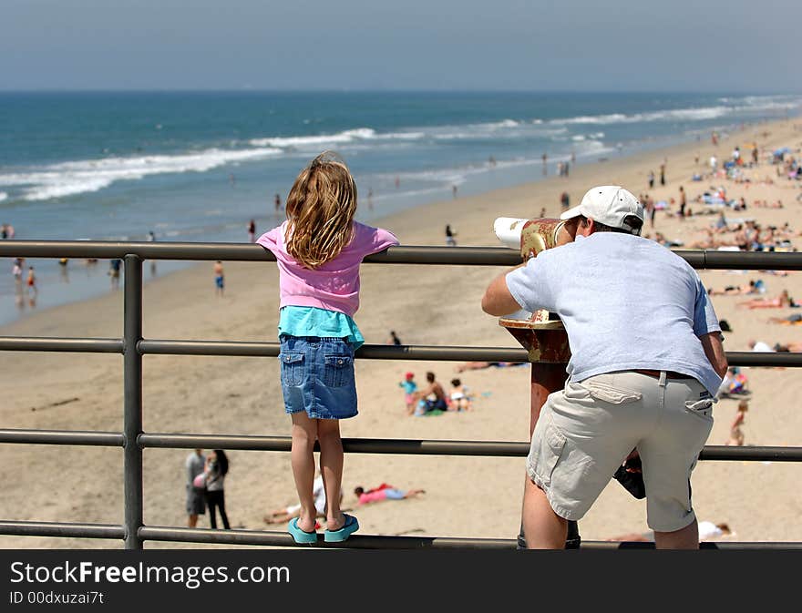 Father and Daughter Examine Coast Through Telescope. Father and Daughter Examine Coast Through Telescope