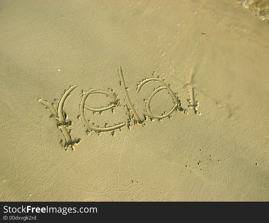 Relax written on the beach sand. Relax written on the beach sand