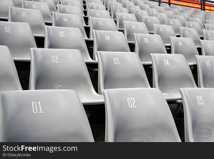 Many Empty Seats In Rows In An Outdoor Stadium. Many Empty Seats In Rows In An Outdoor Stadium