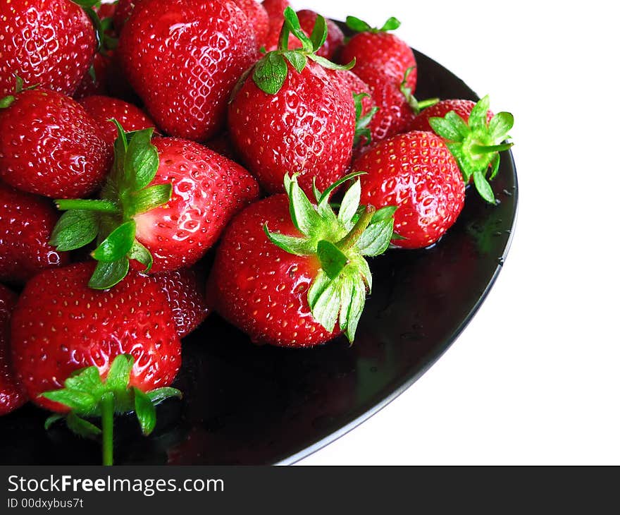 Strawberries on a black plate showing healthy living. Strawberries on a black plate showing healthy living.