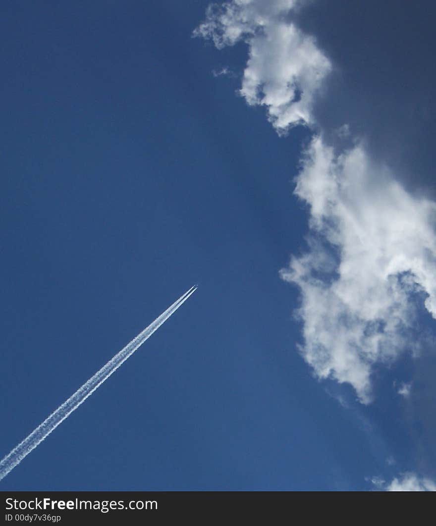 An airplane crossing the blue summer skies. An airplane crossing the blue summer skies