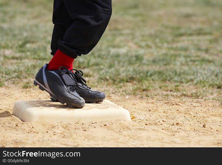 Youths feet on base during game