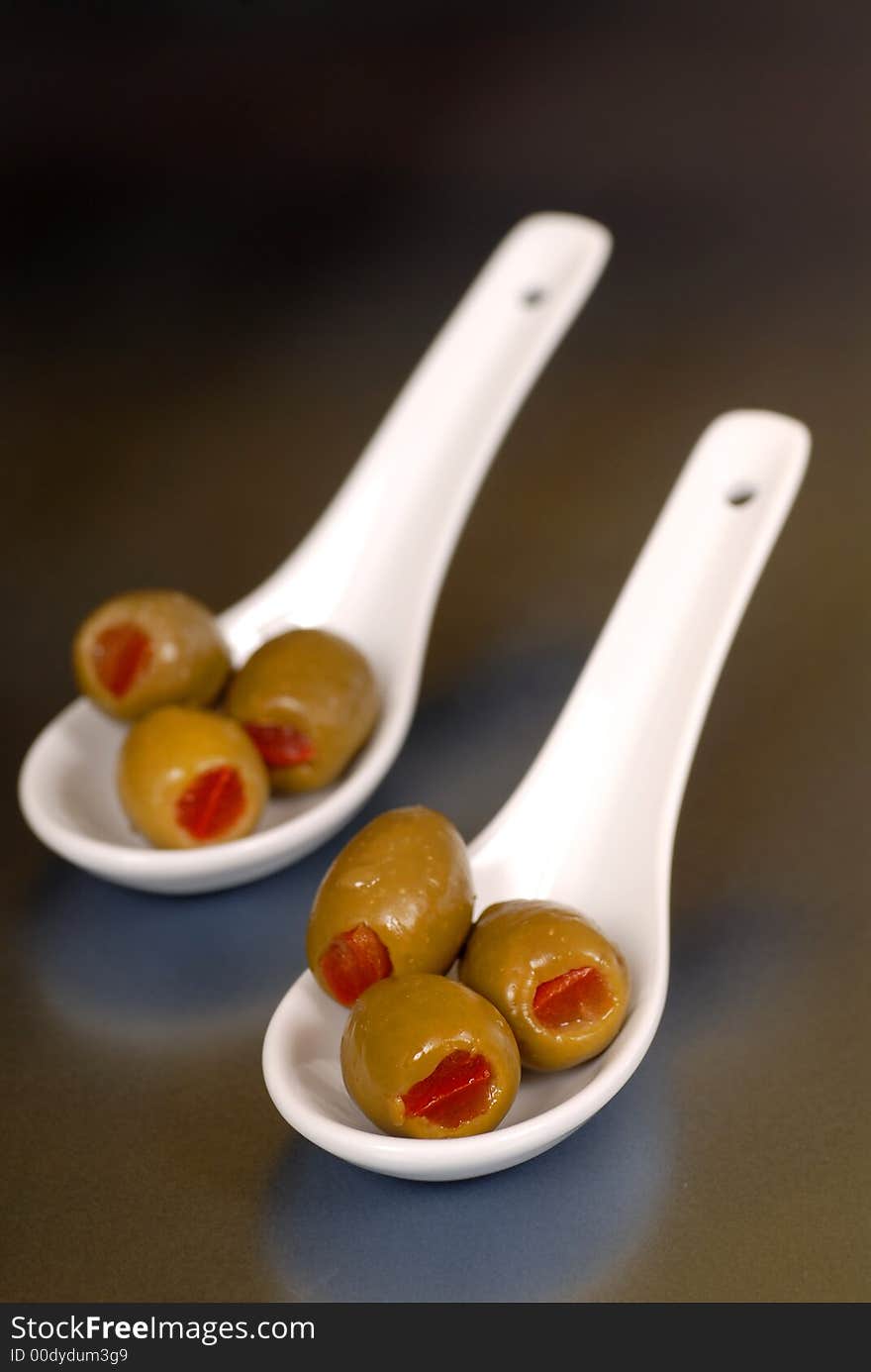 Green stuffed olives in two wh