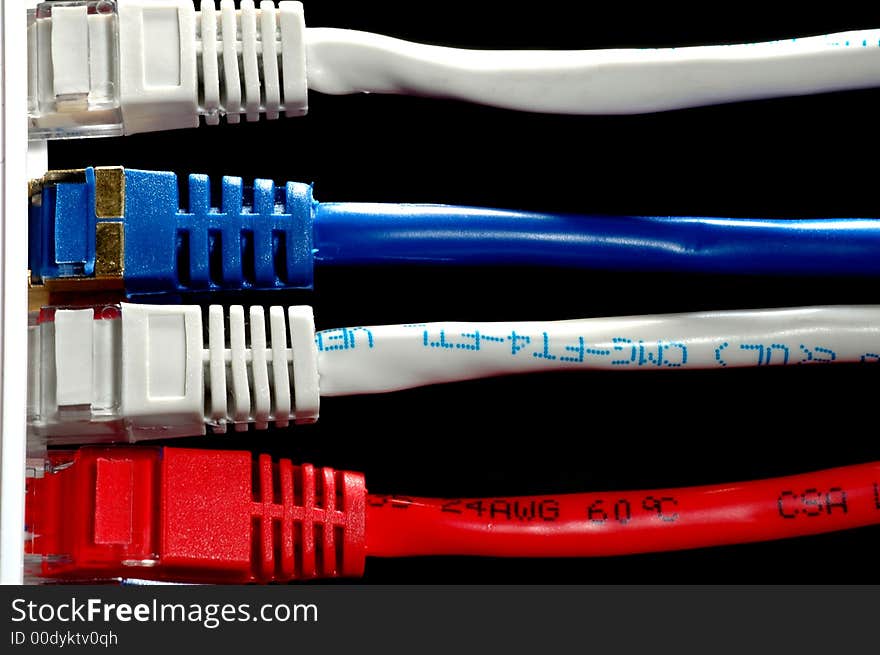 Network cable in three different colors witha black background. Network cable in three different colors witha black background