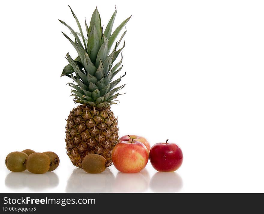 Fresh kiwis, apples and pineapple against white. Fresh kiwis, apples and pineapple against white