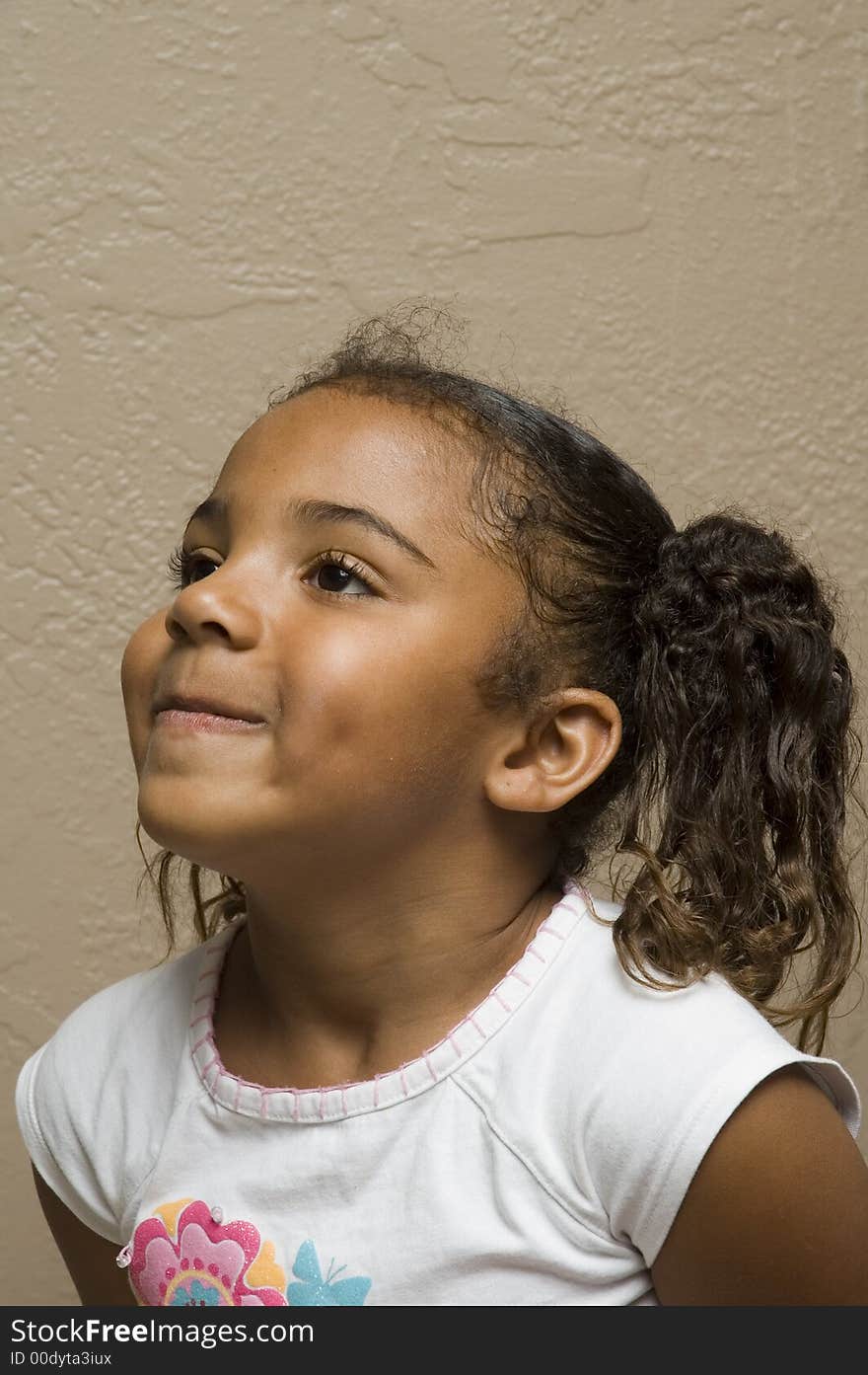 Cute african american child tight lipped because she is missing her front teeth