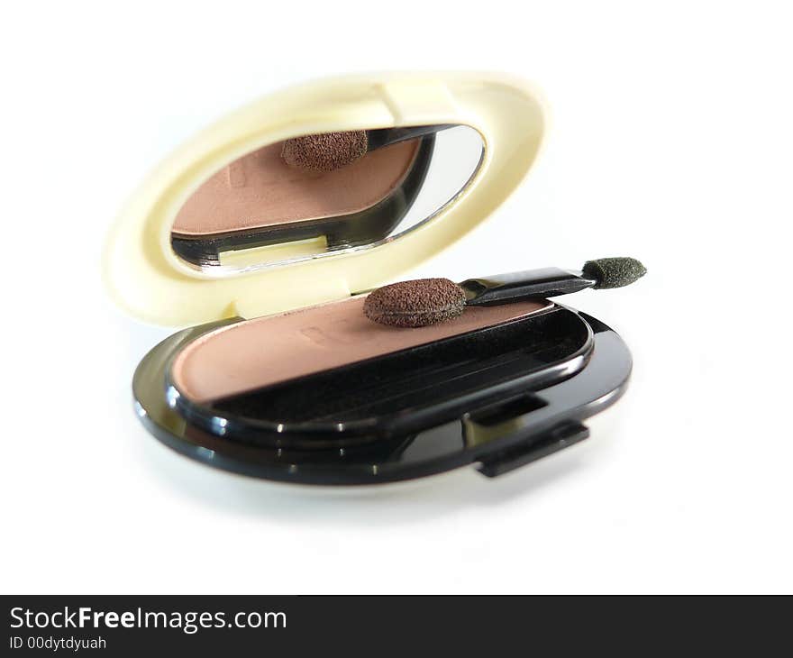 Natural eye shadow in case with mirror on white background