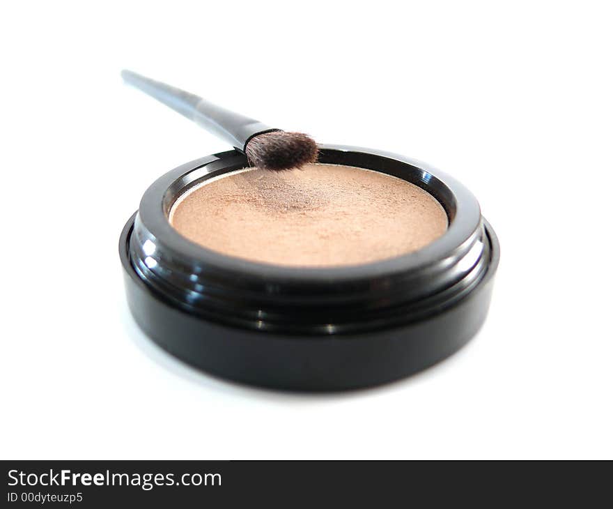 Beige natural eye shadow and brush on white background