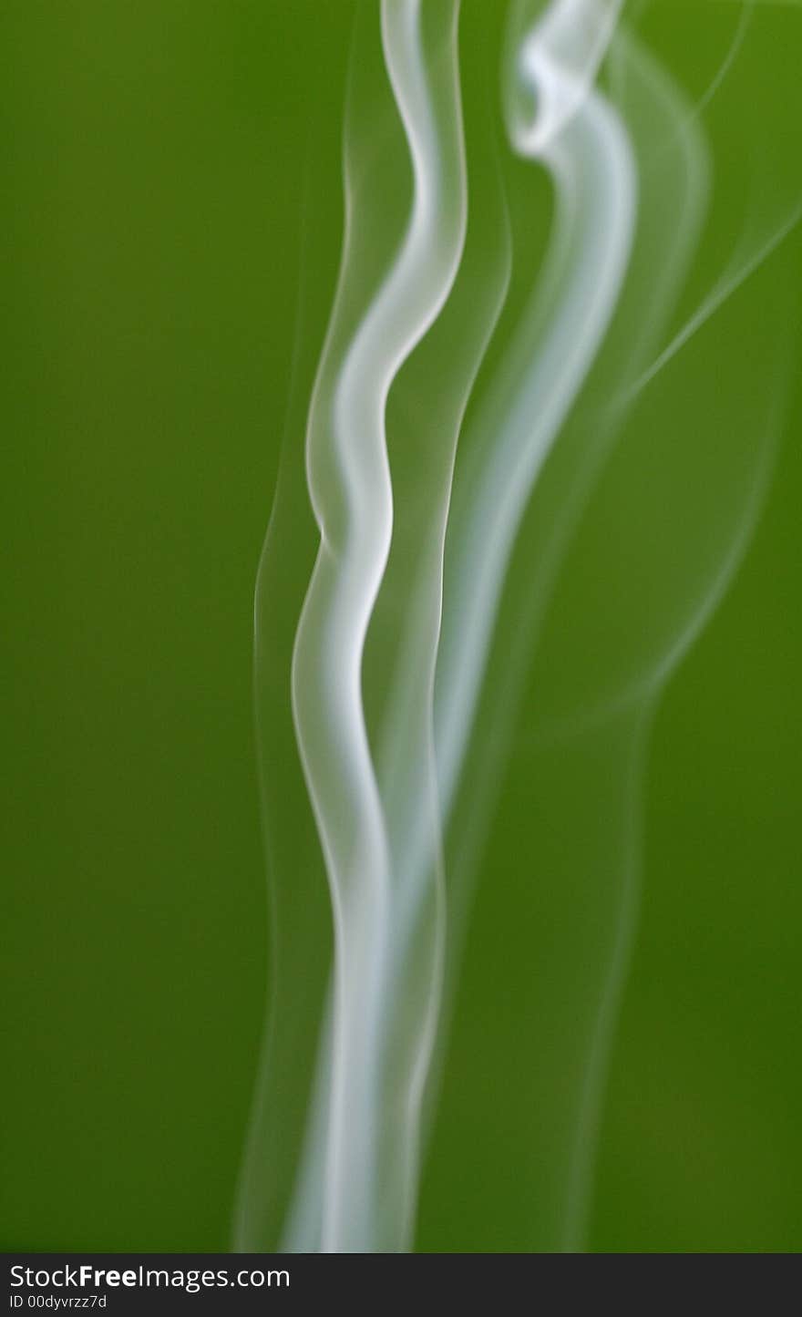 A shot of billowy smoke against a vibrant green backdrop. A shot of billowy smoke against a vibrant green backdrop.