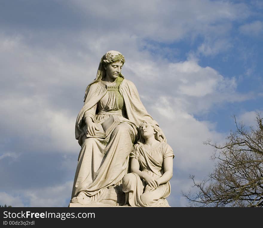 Cemetery monument stone statue woman and child. Cemetery monument stone statue woman and child