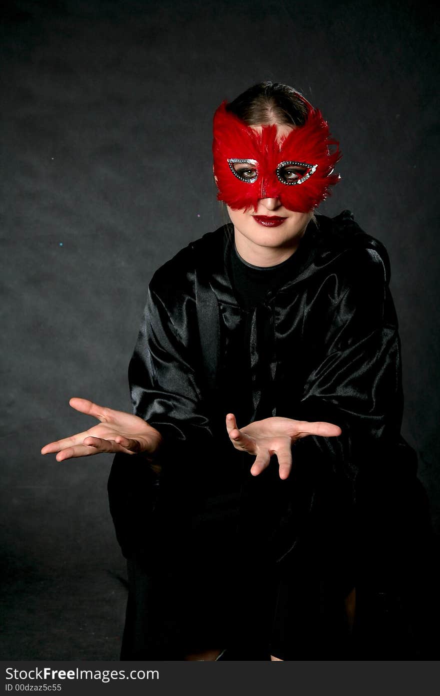 Surprised women in red mask. Make-up black background.