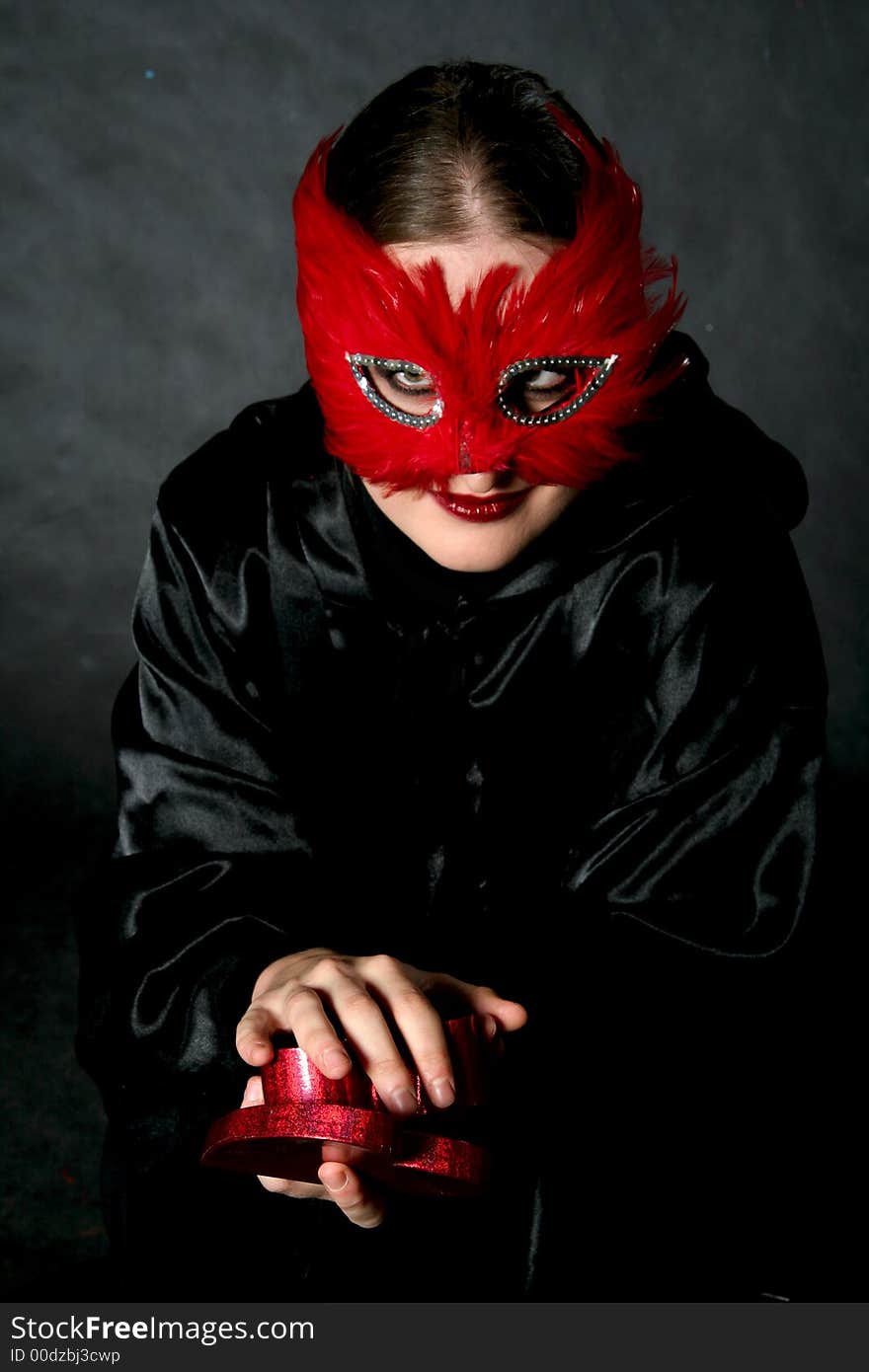 Women in red mask with heart. Make-up black background. Women in red mask with heart. Make-up black background.