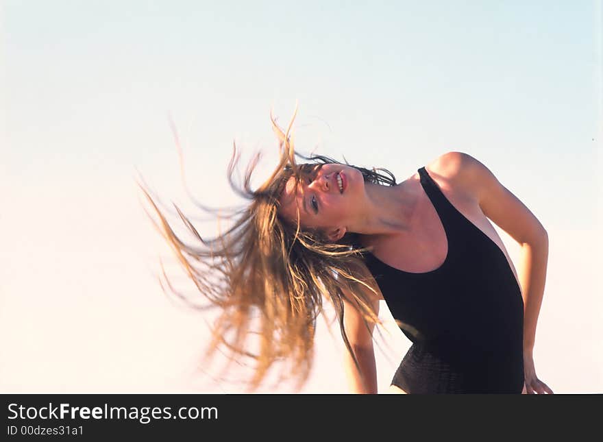 Portrait of  young girl with  dismissed hair on  background of  sky. Portrait of  young girl with  dismissed hair on  background of  sky